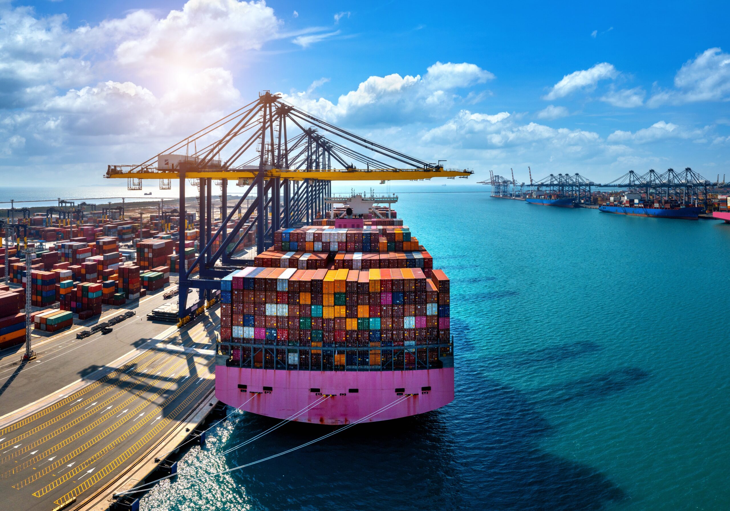 Aerial view of cargo ship and cargo container in harbor. export